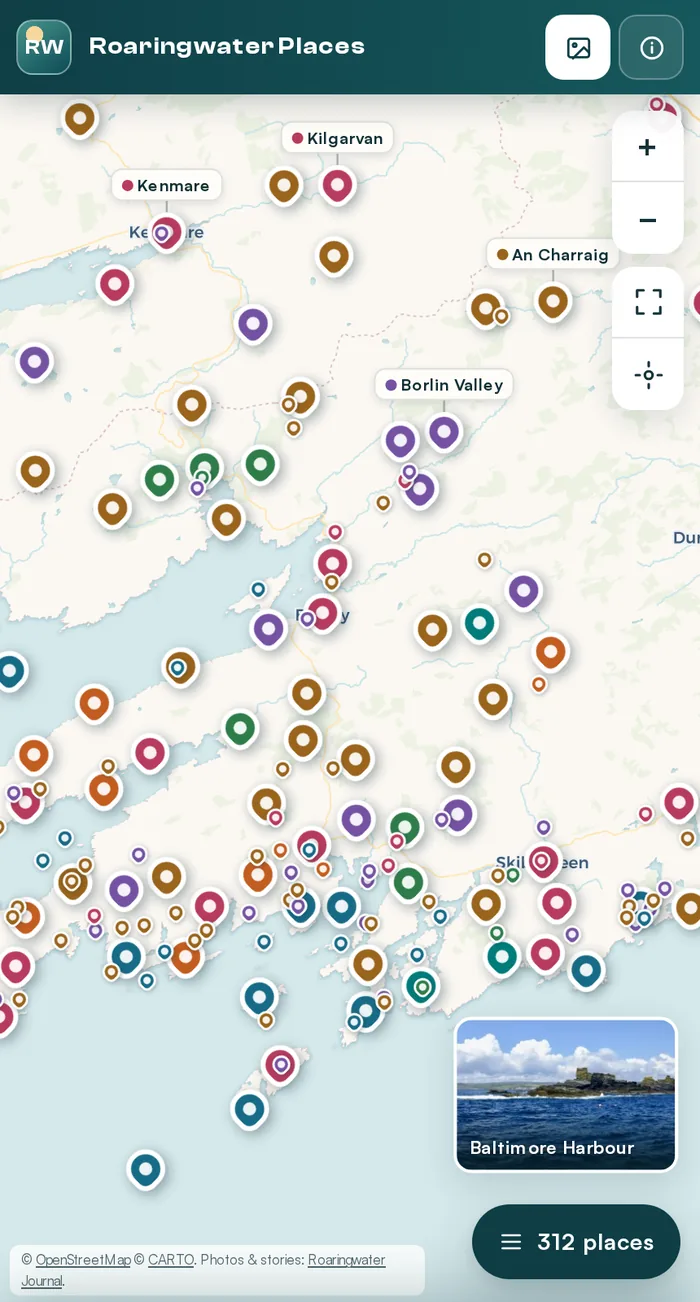 The map on a phone: pins thinned to dots where they crowd, with photo cards for Baile Bhuirne and Baltimore Harbour